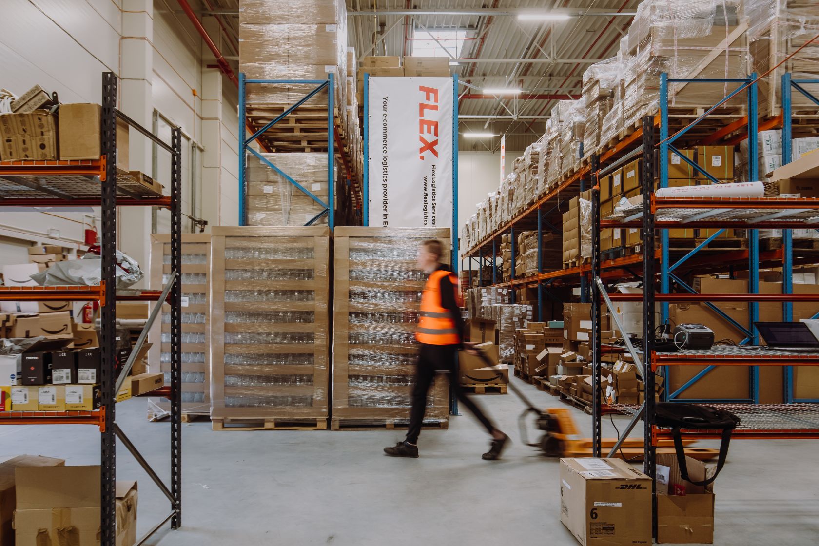 Man pushing a cart through a warehouse