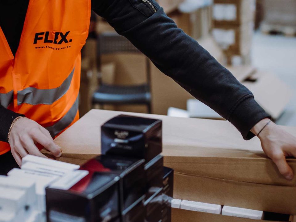 Man wearing Flex vest packing a parcel
