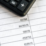 Calculator and financial documents showing VAT calculations for international e-commerce tax compliance