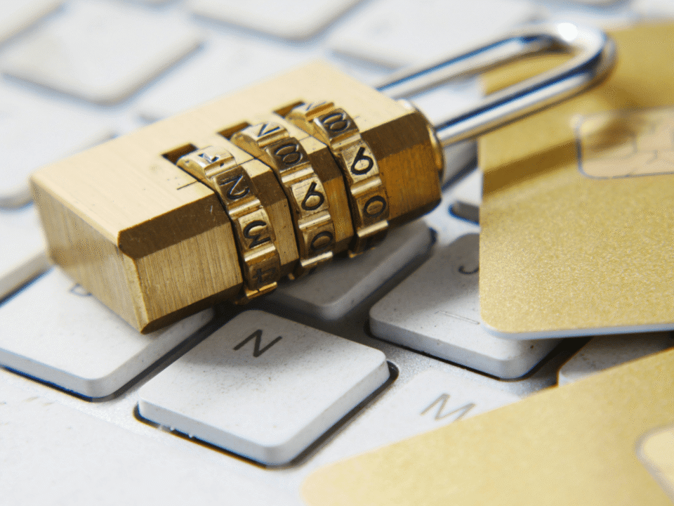 Golden padlock on top of a computer as a symbol of cybersecurity awareness.