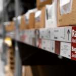 Close-up view of labeled warehouse shelving in a Central-Europe fulfillment center, illustrating organized storage infrastructure for efficient e-commerce logistics.