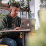 An e-commerce entrepreneur working on a laptop in a modern workspace, symbolizing digital business growth and scaling operations in Europe.
