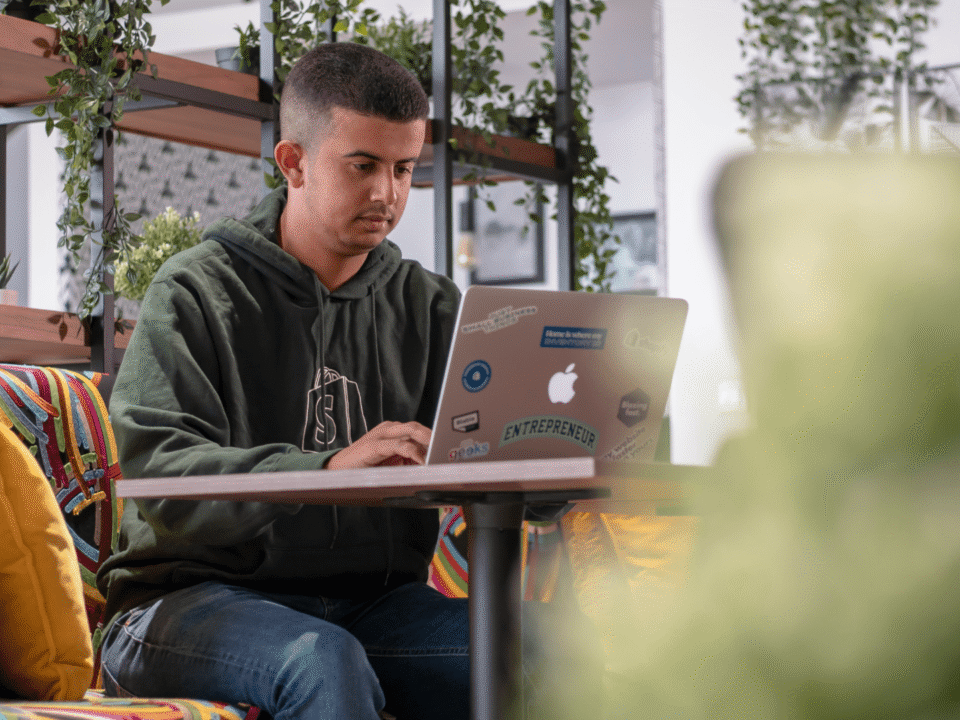 An e-commerce entrepreneur working on a laptop in a modern workspace, symbolizing digital business growth and scaling operations in Europe.