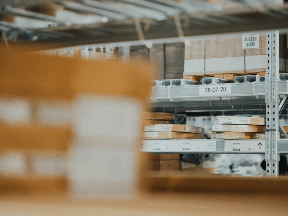 Eco-friendly warehouse shelves storing flat-packed products prepared for sustainable dropshipping logistics in Europe.