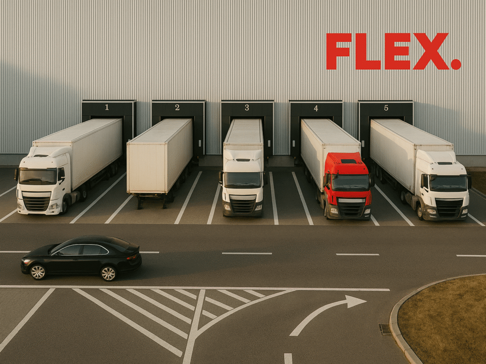 Front view of a modern European fulfillment warehouse with a large red FLEX. logo above five loading docks, where white delivery trucks are parked and ready for dispatch.
