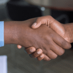 Business partners shaking hands after establishing a reliable fulfillment and logistics partnership to support operations in Europe.