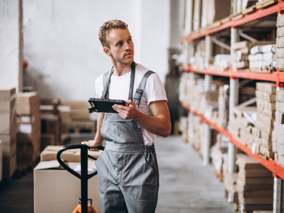 Warehouse picker moving efficiently through optimized aisles to reduce travel time.