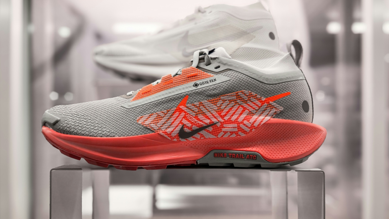 Close-up of a modern trail running shoe with technical design features and textured sole for outdoor sports performance.