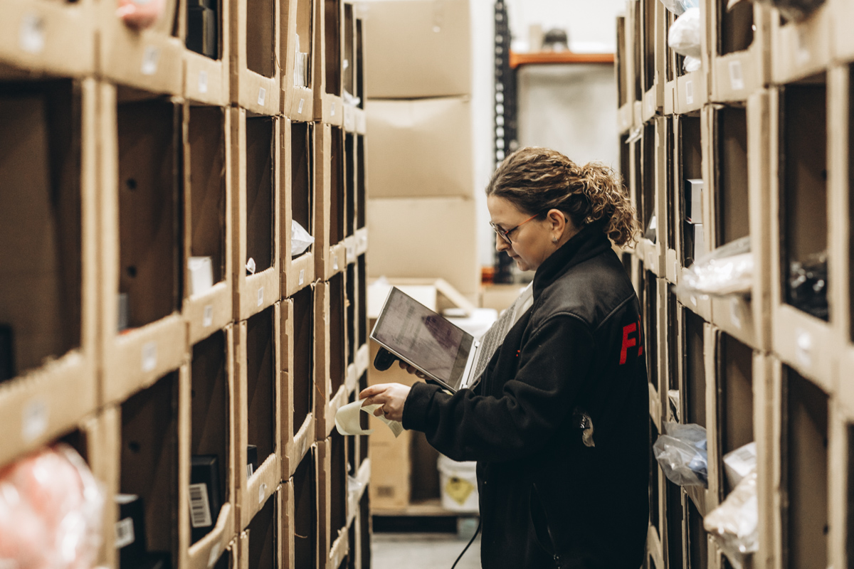 FLEX warehouse team member picking stock from warehouse shelving