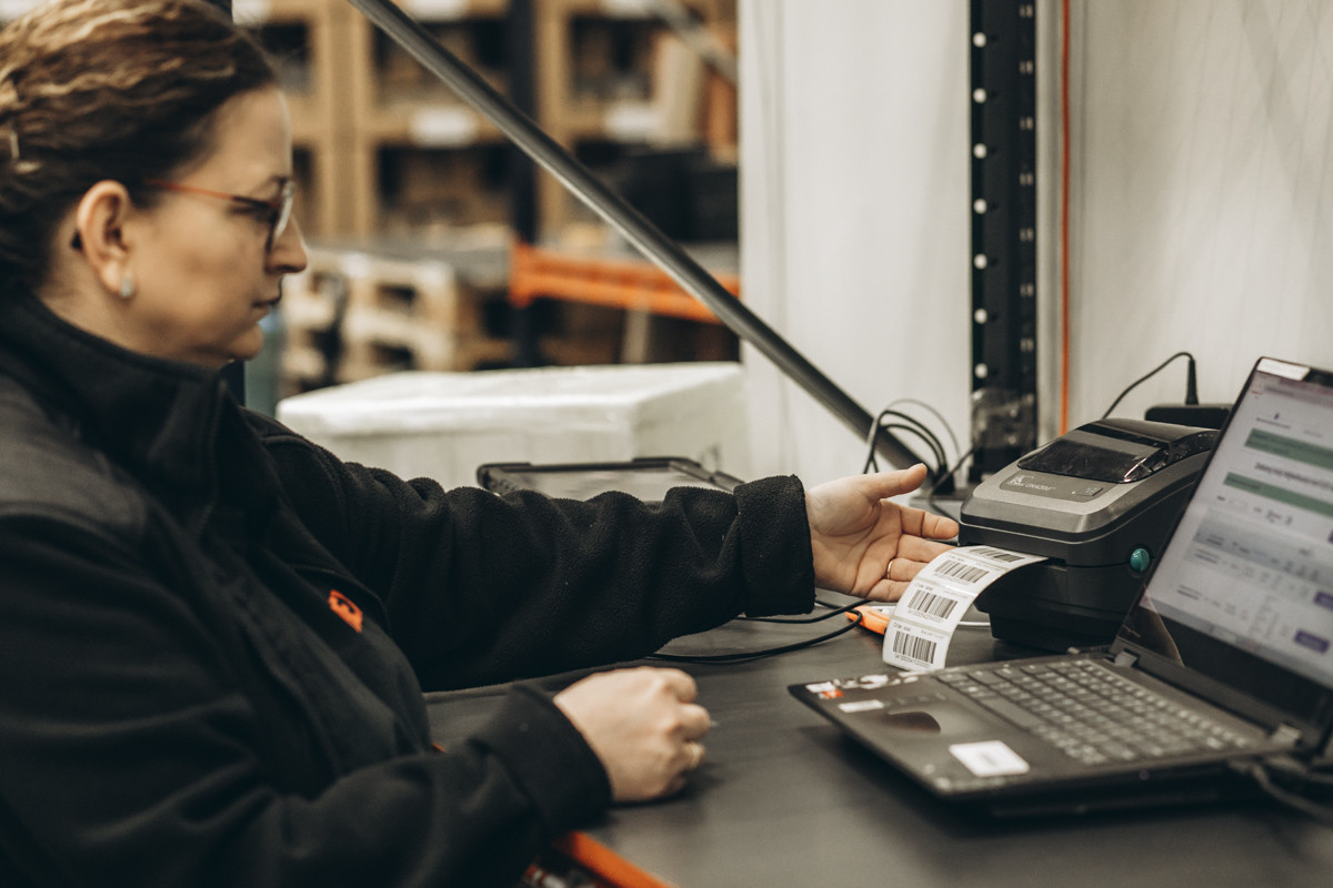 FLEX warehouse team member using a tablet to manage inventory and fulfilment operations