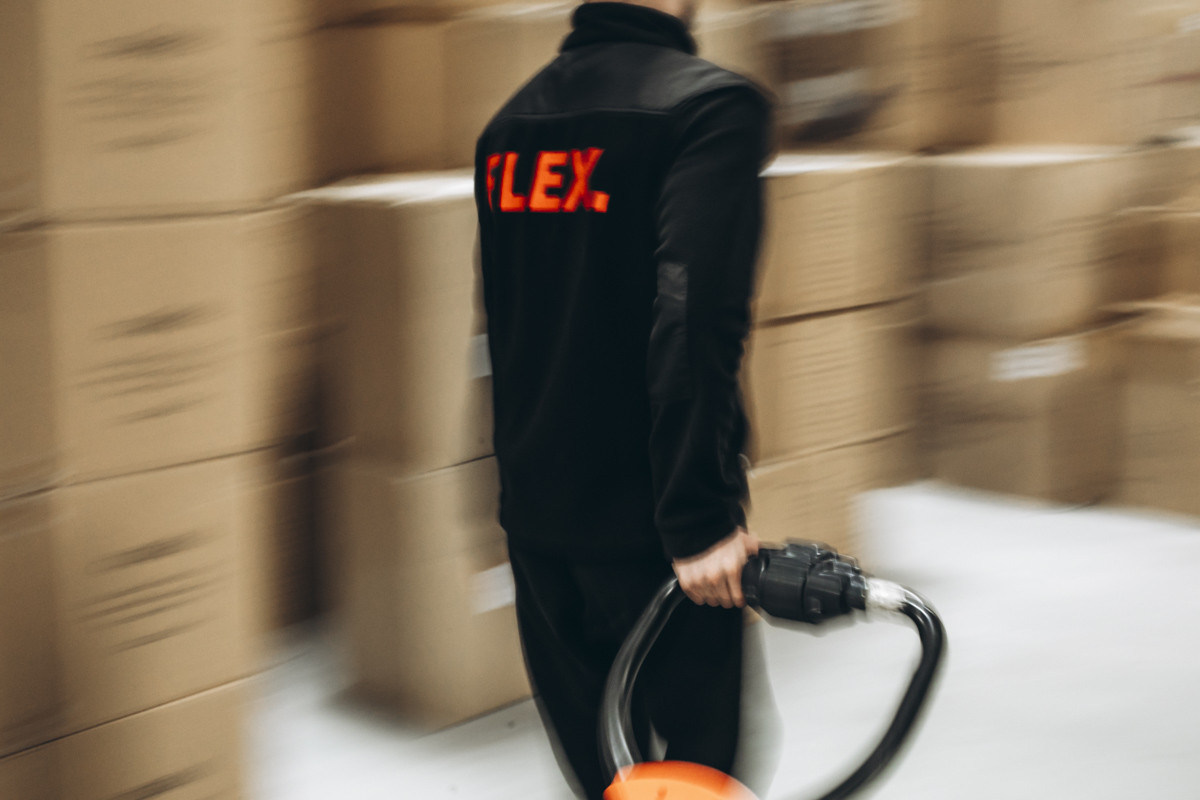 FLEX warehouse team member moving palletised stock in a fulfilment centre